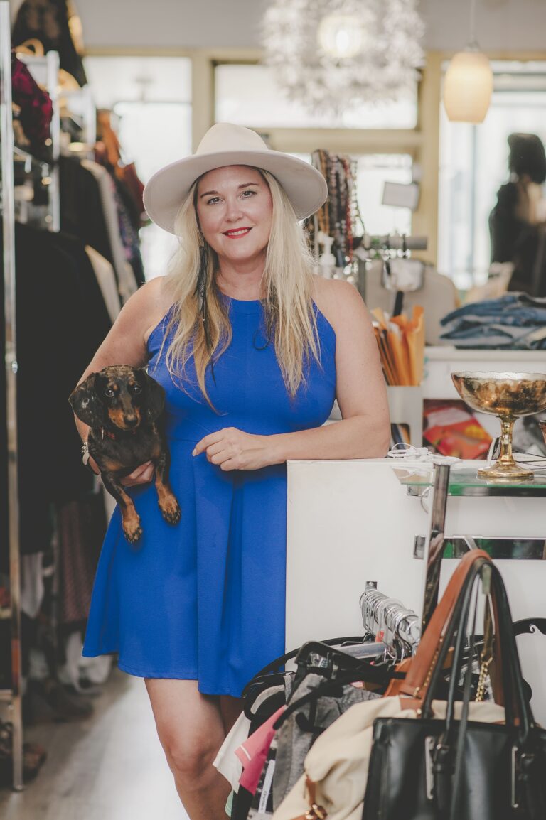 Owner Michelle Planche poses with Spud in Loved & Found Boutique